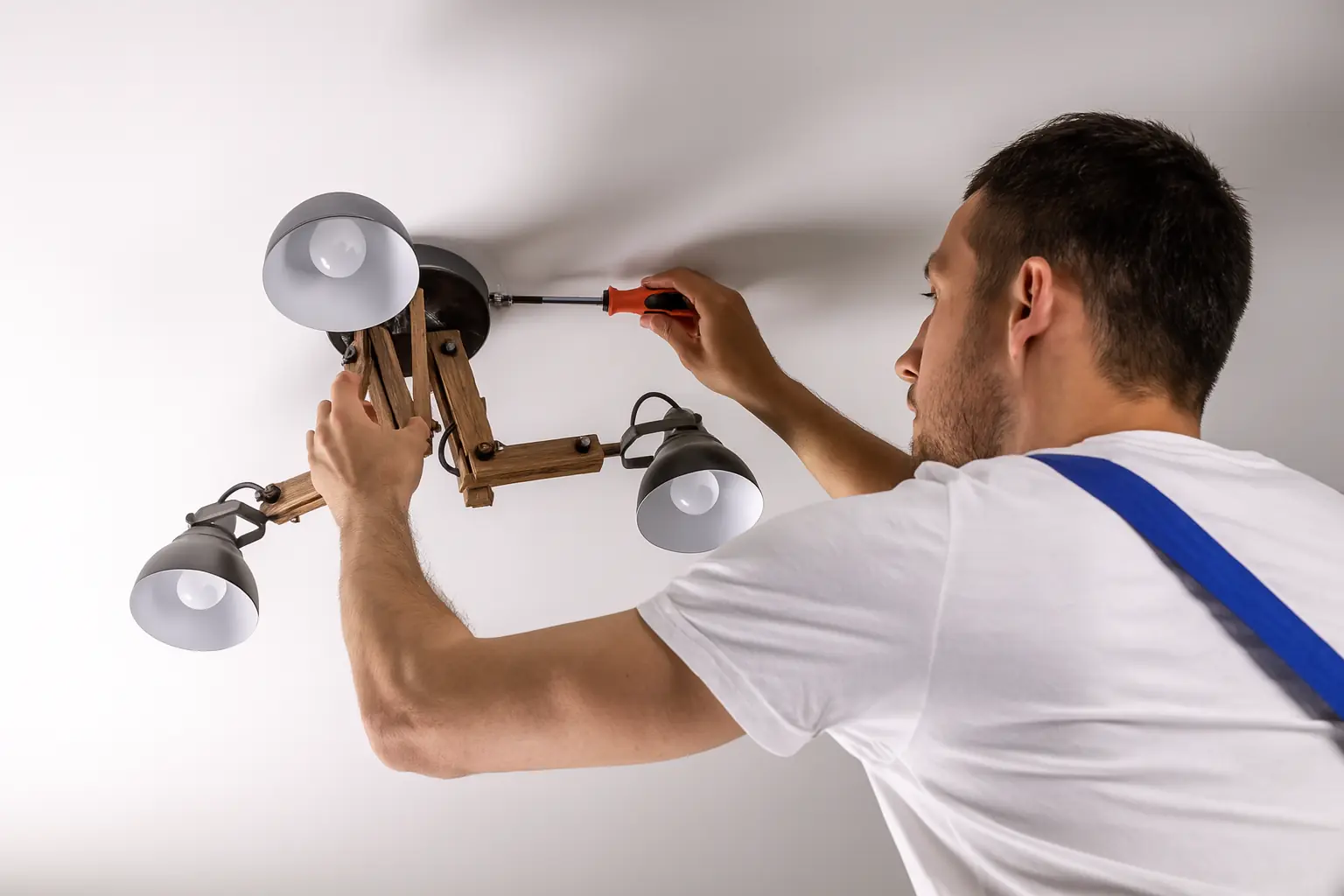 handyman electrician installing ceilinglight fixing wiring